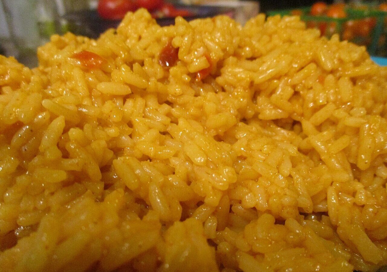 Close-up of fluffy, separate grains of Spanish-style rice cooked with tomato and peppers
